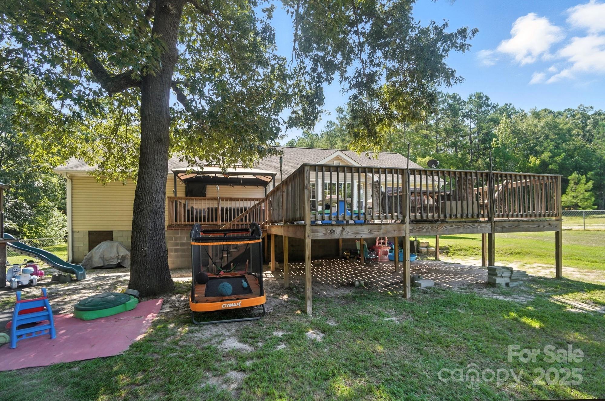 1116 State Rd S-29-770 Kershaw, SC 29067 - Photo 48 of 48 a view of a deck with a table chairs and a slide