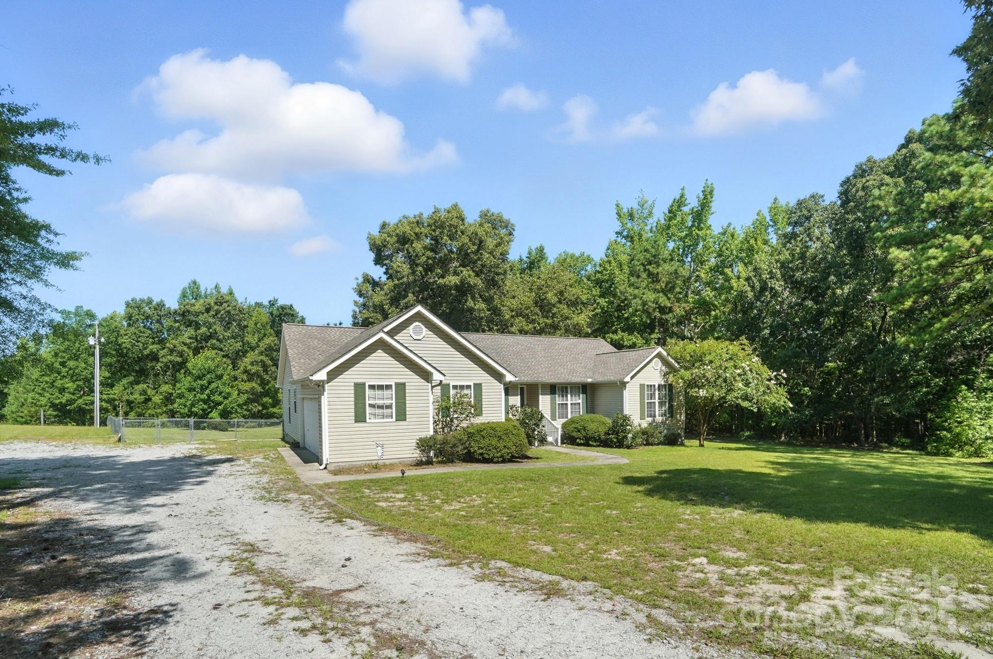 1116 State Rd S-29-770 Kershaw, SC 29067 - Photo 5 of 48 a front view of a house with garden