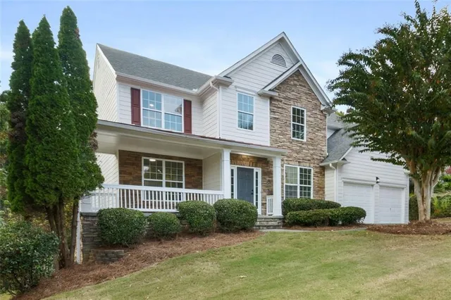 a front view of a house with a yard and garage