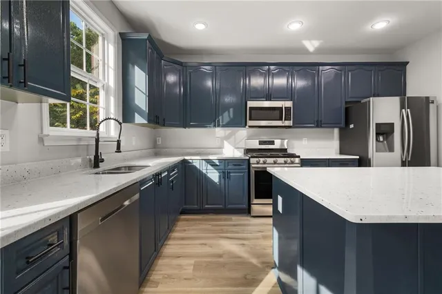 a kitchen with stainless steel appliances granite countertop a sink stove and oven