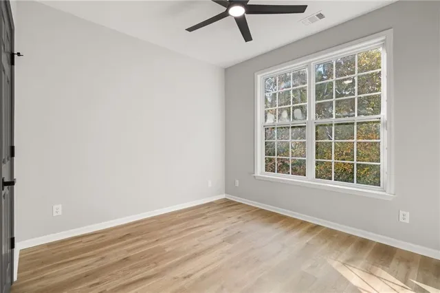 a spacious bedroom with a large bed and a window