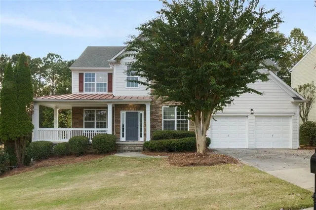a view of a house with a yard and garage