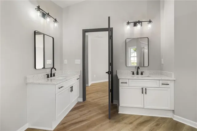 a view of a livingroom with wooden floor and a ceiling fan