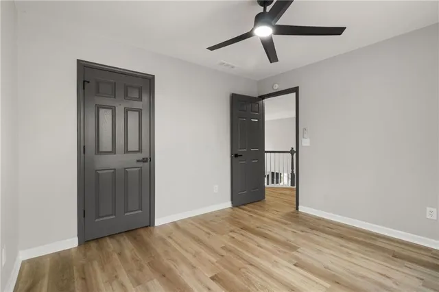 a view of an empty room with a kitchen and a sink