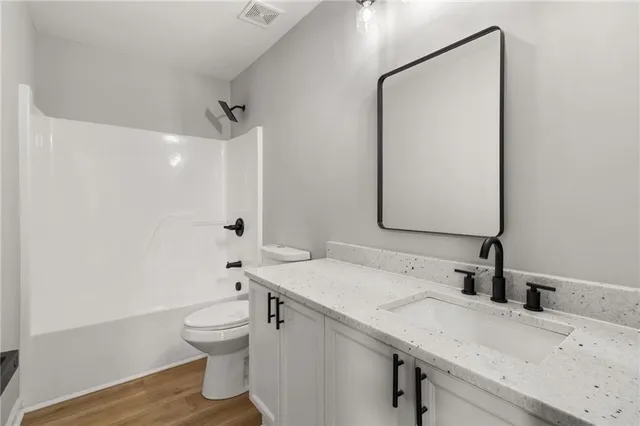 a kitchen with stainless steel appliances granite countertop a refrigerator a sink and a stove