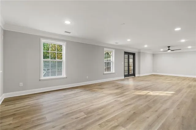 a kitchen with a sink cabinets and wooden floor