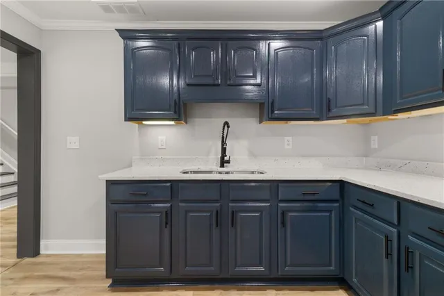 a view of a hallway with wooden floor and a bathroom