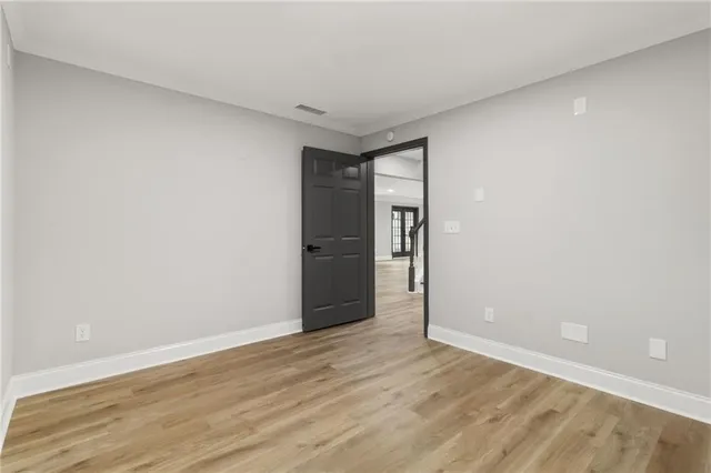 a view of a house with a yard and wooden fence