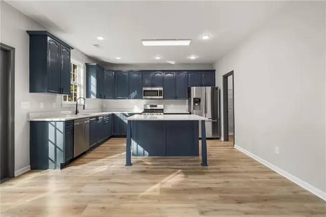 a kitchen with granite countertop a stove and a wooden floors