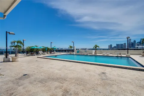 a view of swimming pool with outdoor seating and city view