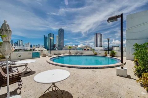 a view of a kitchen with a table and chairs