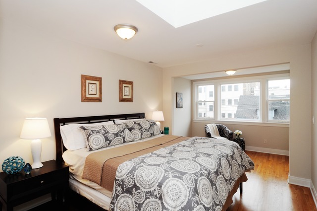 1457 West Rascher Avenue Chicago, IL 60640 - Photo 12 of 22 a bedroom with a bed and a window