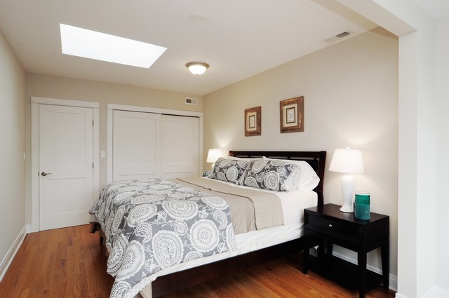 1457 West Rascher Avenue Chicago, IL 60640 - Photo 13 of 22 a bedroom with a bed and wooden floor