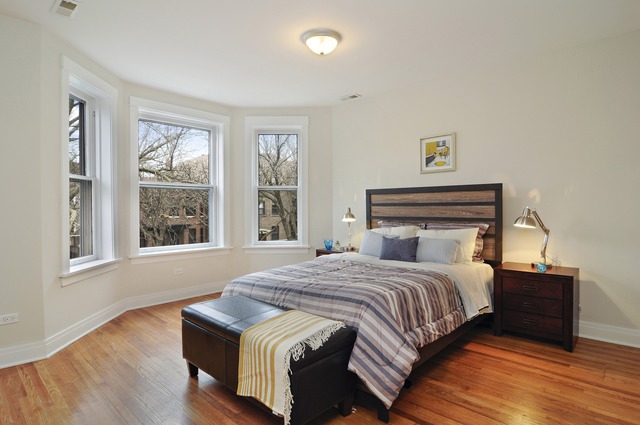 1457 West Rascher Avenue Chicago, IL 60640 - Photo 16 of 22 a bedroom with a bed and wooden floor