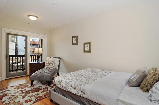 1457 West Rascher Avenue Chicago, IL 60640 - Photo 17 of 22 a bedroom with a bed and wooden floor