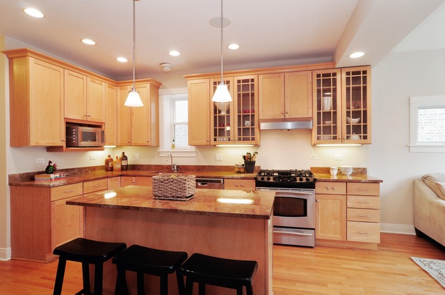 1457 West Rascher Avenue Chicago, IL 60640 - Photo 5 of 22 a kitchen with stainless steel appliances granite countertop a stove top oven a sink dishwasher a dining table and chairs with wooden floor