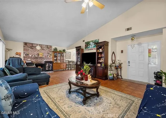 a living room with furniture a rug and a chandelier
