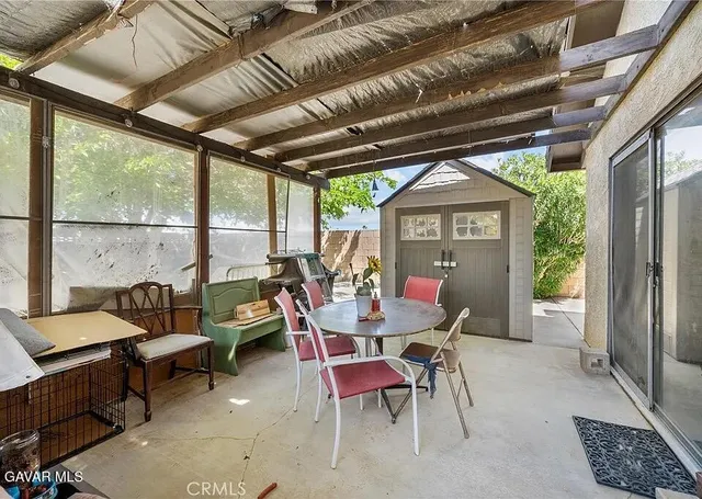 a dining room with furniture a rug and a large window