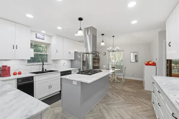 a kitchen with stainless steel appliances granite countertop a sink stove and refrigerator