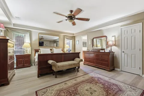 a living room with furniture a ceiling fan and a window