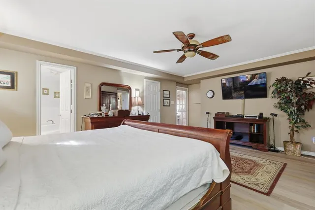 a bedroom with a bed desk and a window