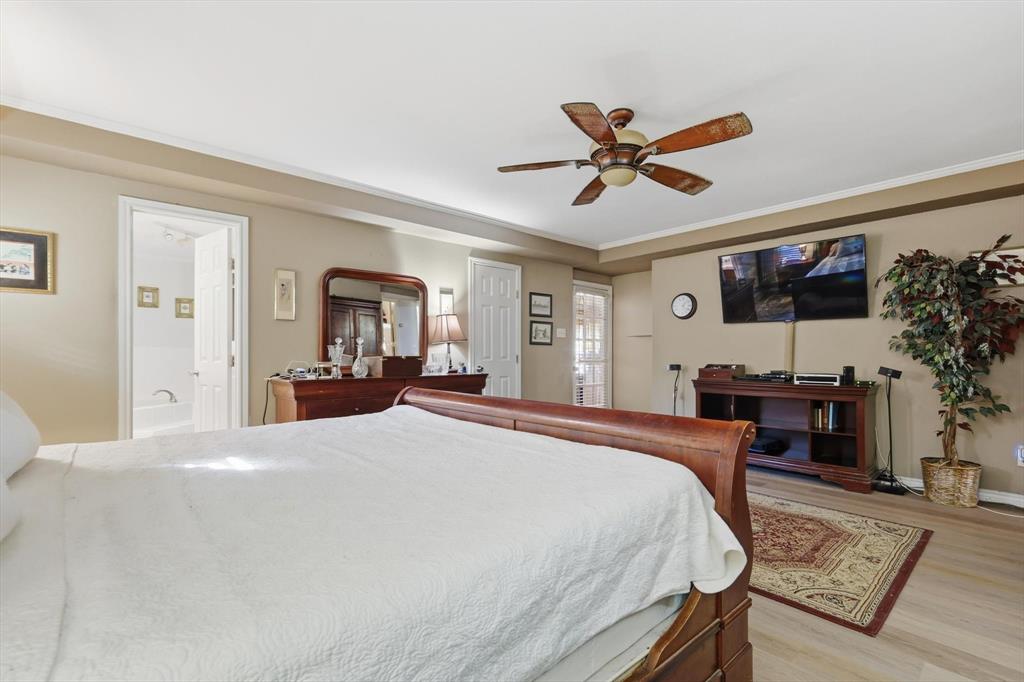 4208 Bretton Bay Circle Dallas, TX 75287 - Photo 15 of 32 a bedroom with a bed desk and a window