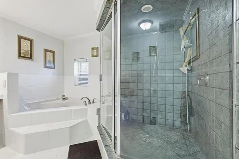 a bathroom with a bathtub and shower