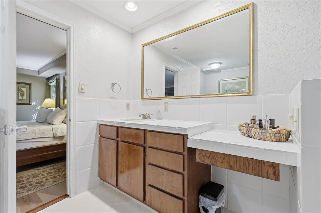 4208 Bretton Bay Circle Dallas, TX 75287 - Photo 17 of 32 a en suite bathroom with a sink double vanity and a mirror