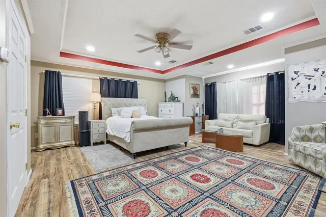 a bedroom with a large bed and a chandelier