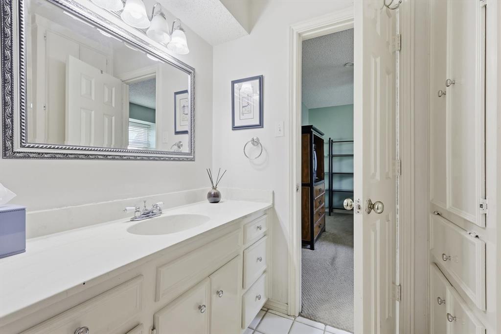 4208 Bretton Bay Circle Dallas, TX 75287 - Photo 22 of 32 a bathroom with a sink vanity and a mirror