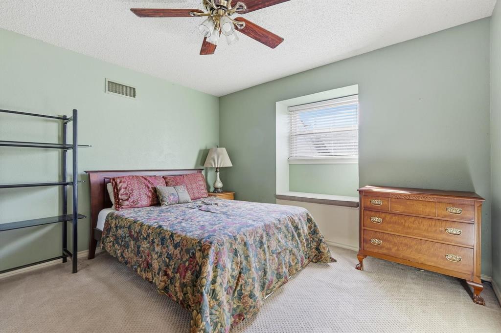 4208 Bretton Bay Circle Dallas, TX 75287 - Photo 23 of 32 a bedroom with a bed and a dresser