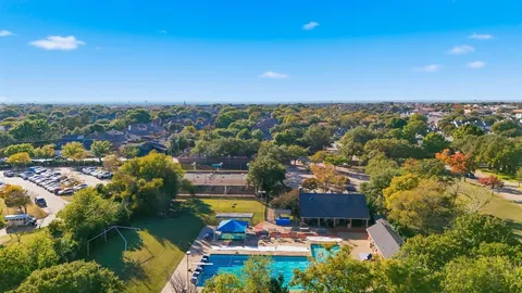 an aerial view of residential houses with outdoor space and lake view