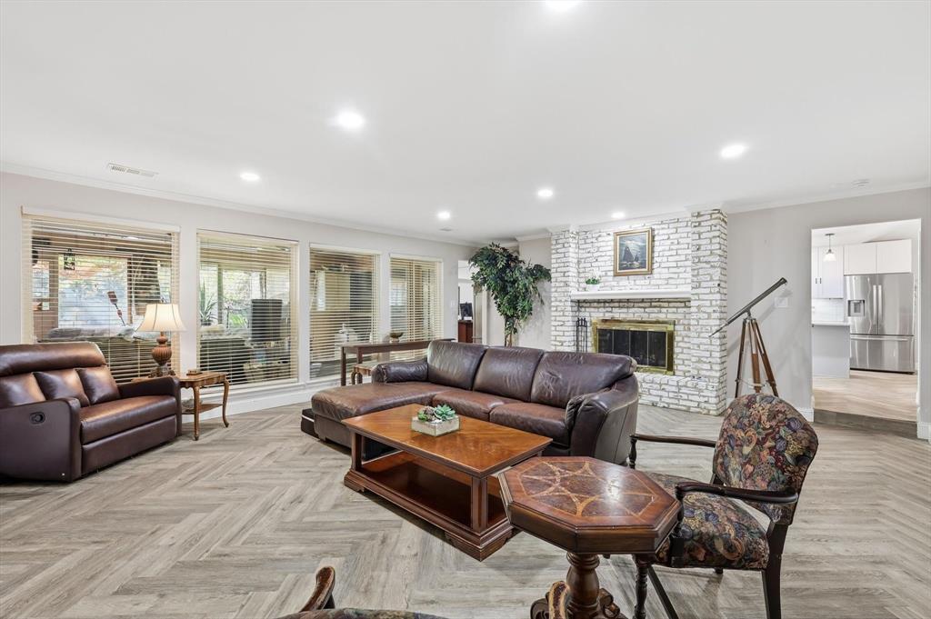 4208 Bretton Bay Circle Dallas, TX 75287 - Photo 3 of 32 a living room with furniture and a fireplace