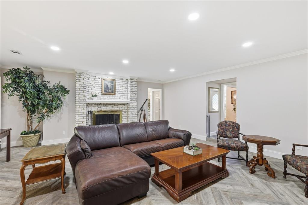 4208 Bretton Bay Circle Dallas, TX 75287 - Photo 4 of 32 a living room with furniture a fireplace and a potted plant