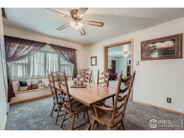 a view of a dining room with furniture and a chandelier