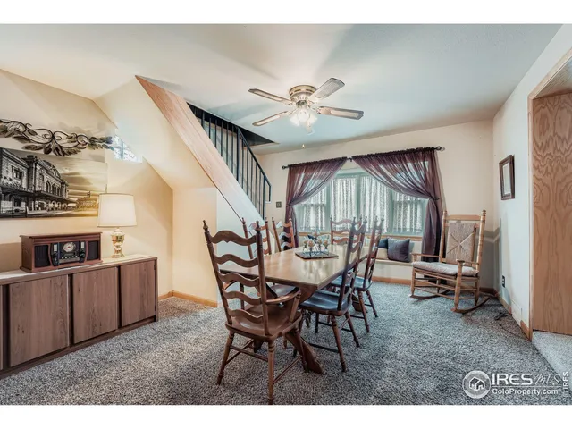 a view of a dining room with furniture and a chandelier