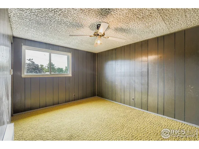 a view of a patio with table and chairs potted plants and floor to ceiling window