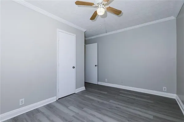 a view of an empty room with wooden floor