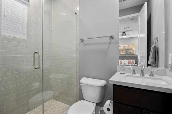 a bathroom with a sink toilet and shower