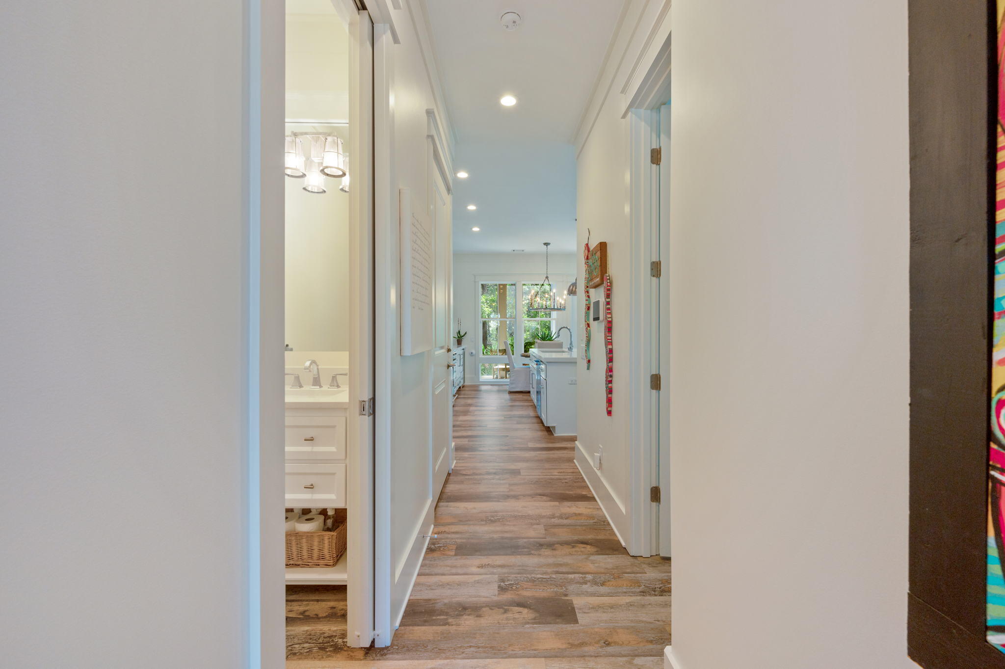 295 Matt's Way Santa Rosa Beach, FL 32459 - Photo 4 of 48 a view of a hallway with wooden floor and a bathroom