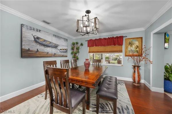 a view of a dining room with furniture wooden floor and a chandelier