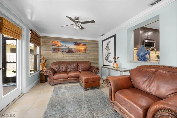 a living room with furniture and a glass door