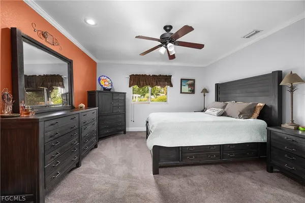 a bedroom with a bed and a dresser