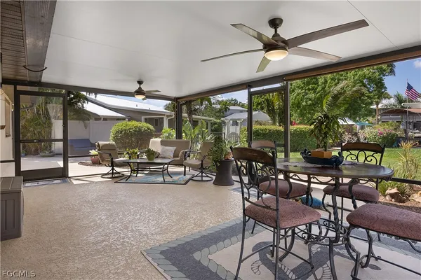 a view of a dining room with furniture water view and a floor to ceiling window