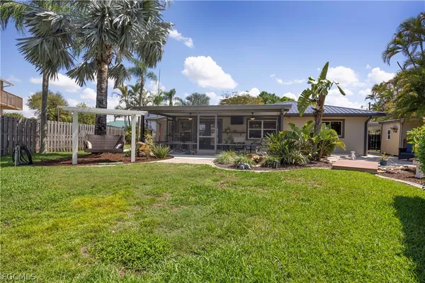 a view of a house with a backyard
