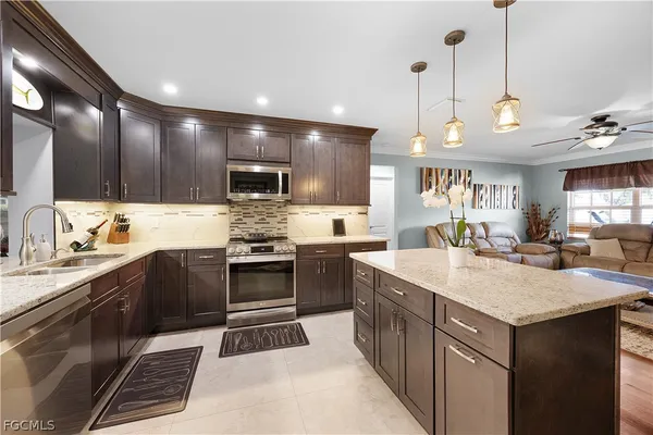 a kitchen with a sink stainless steel appliances and cabinets