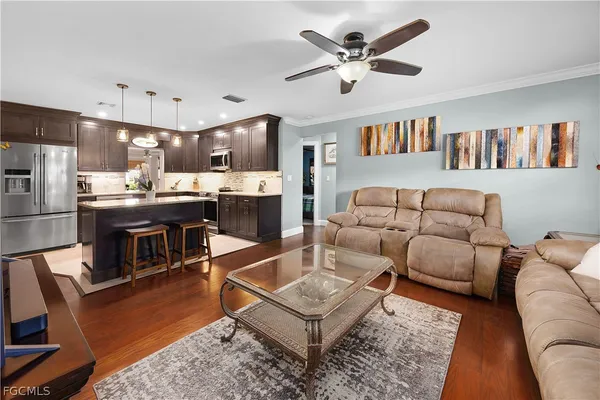 a living room with furniture and a kitchen view