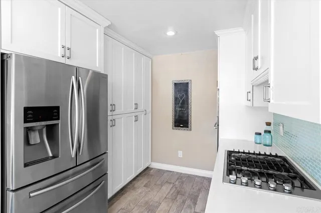 a kitchen with stainless steel appliances white cabinets and a sink