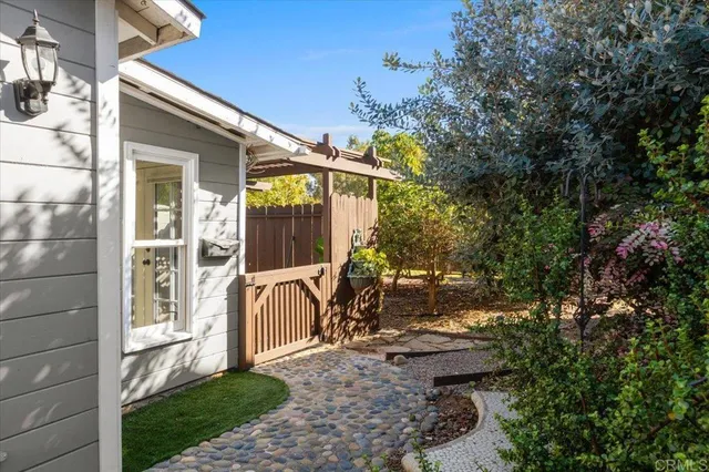 a backyard of a house with flower plants
