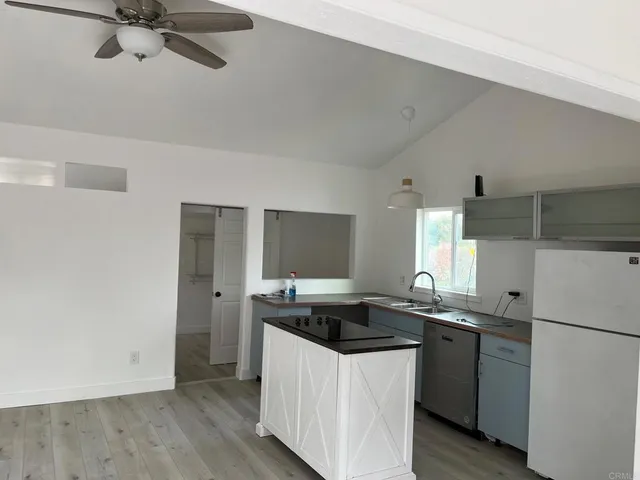 an empty room with a stove and a window